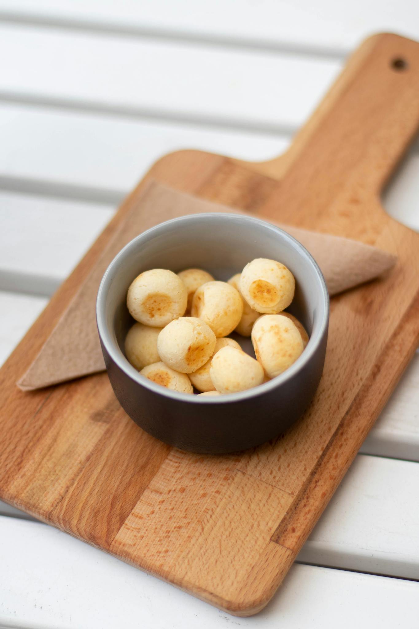 Baked Breads on Round Black and White Ceramic Bowl on the Top of Brown Chopping Board
