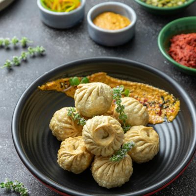 Fried Round Dumplings on Black Ceramic Bowl
